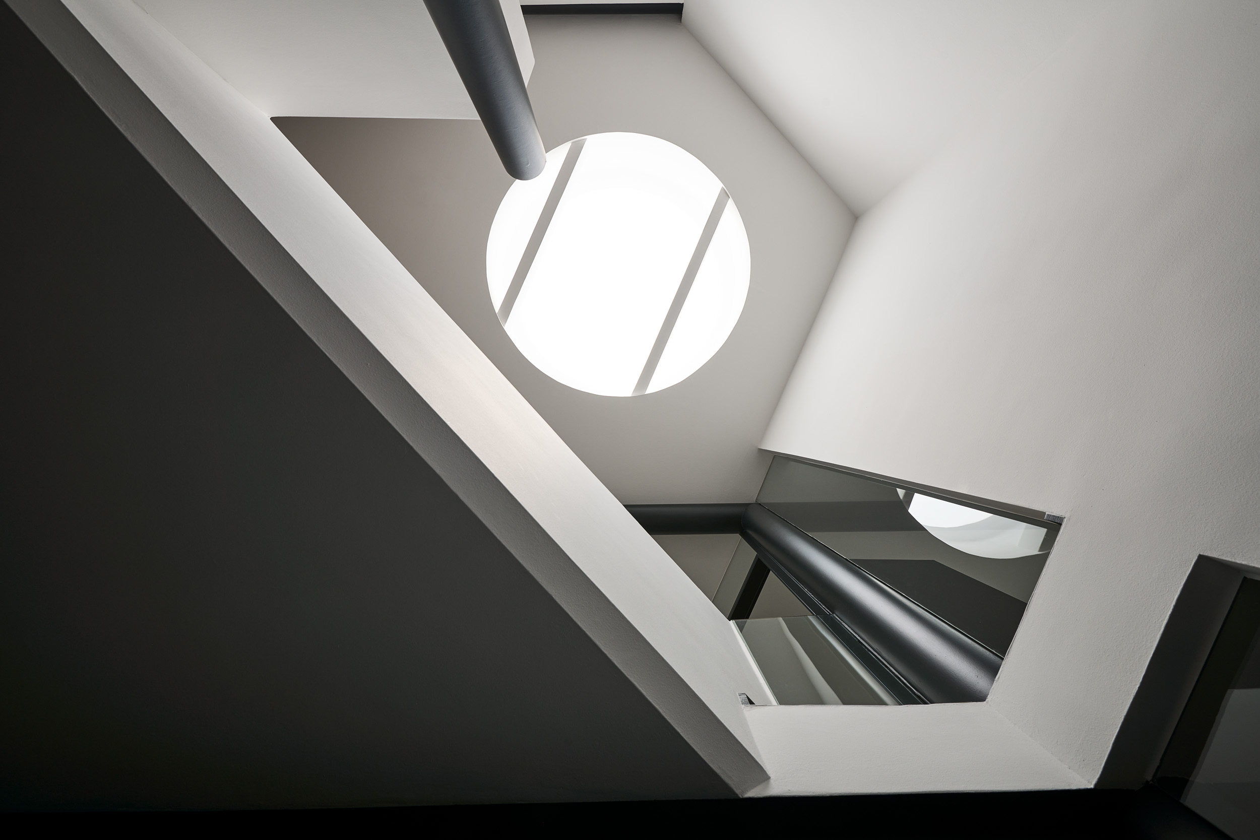 Blick nach oben: Neugestaltung Treppenaufgang und Flur mit rundem Bullaugenfenster in der Decke  – vielseitige Innenarchitektur von Raumideen.